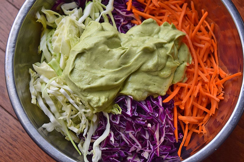 Ingredients for creamy California Avocado coleslaw in a bowl